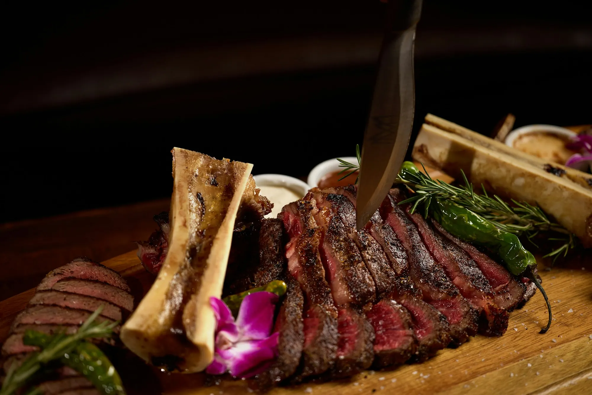 Sliced steak with roasted bone marrow